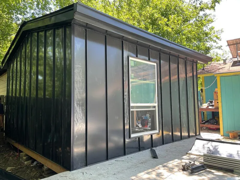 Black standing seam metal wall panels for Roof Inspection in Alvin